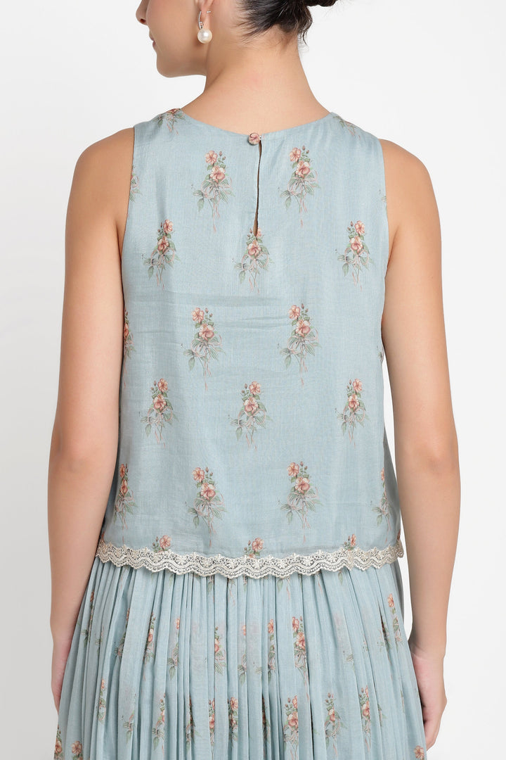 Light blue sleeveless dress with floral embroidery on a white background