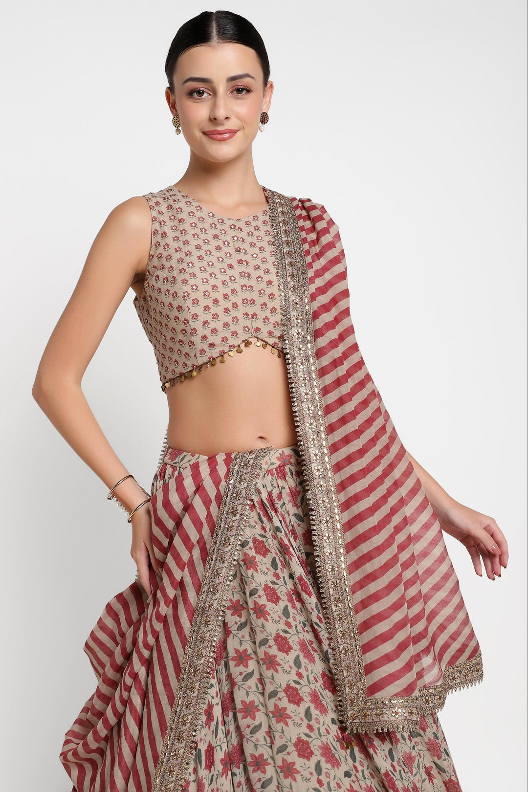 Woman wearing a traditional outfit with a red and beige pattern on a white background