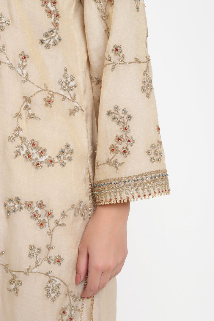 Beige embroidered garment with floral patterns on a white background