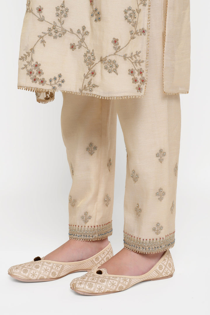Beige embroidered outfit with matching shoes on a white background