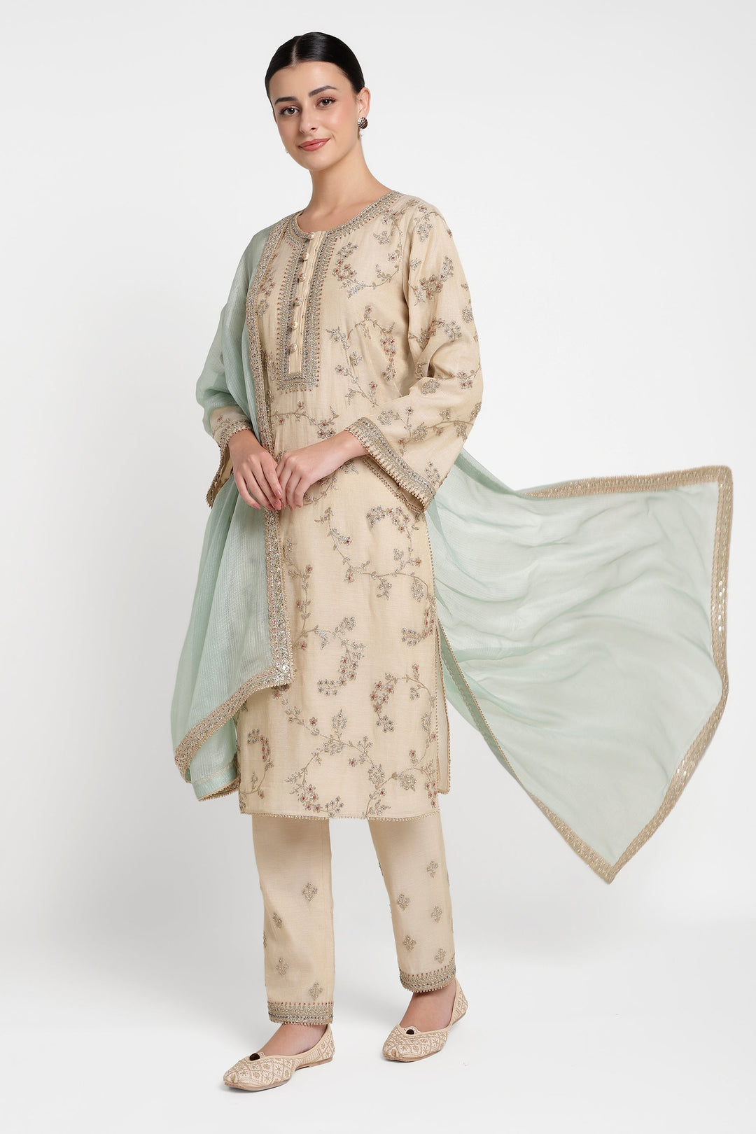 Woman wearing a traditional outfit with a floral pattern on a white background