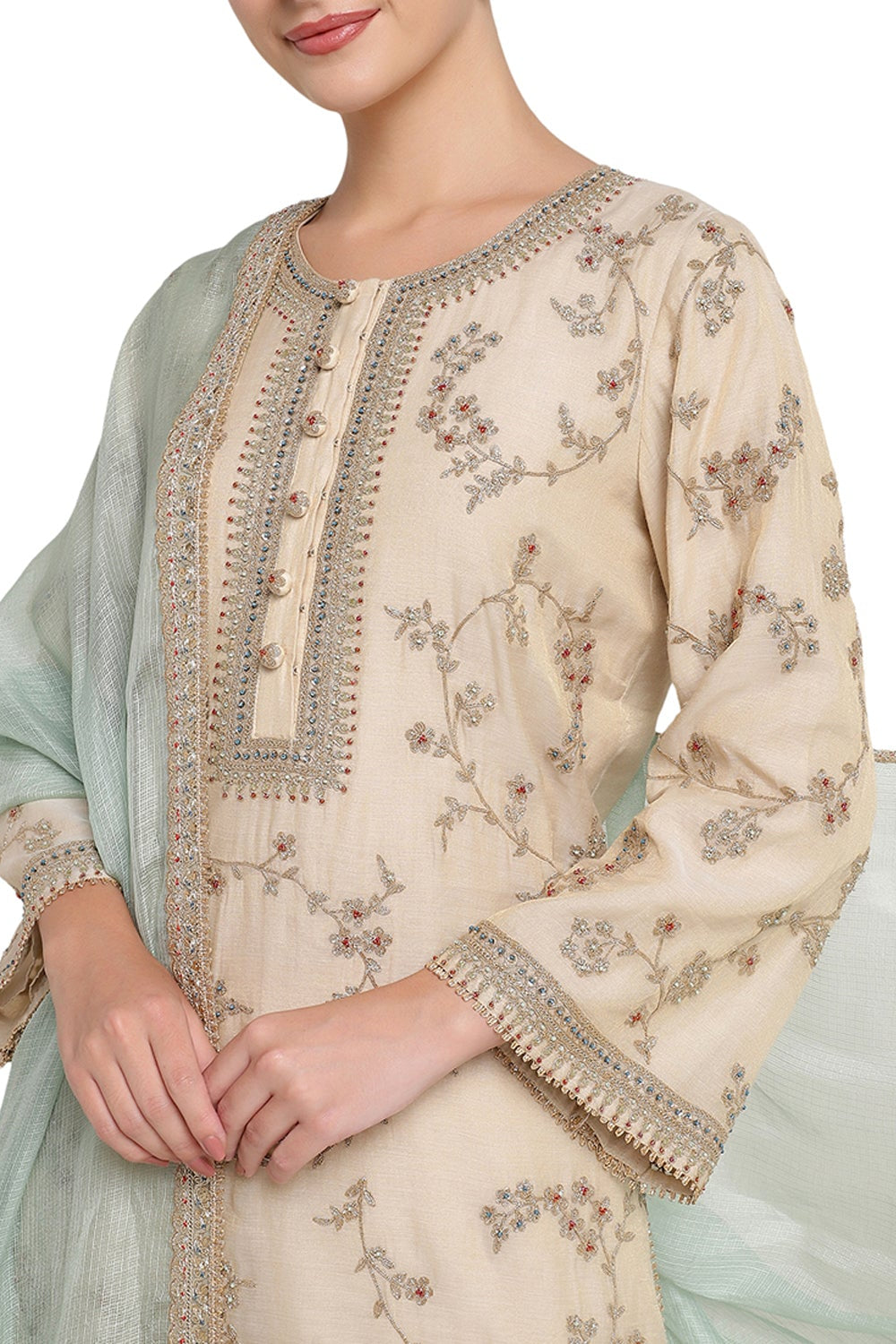 Beige embroidered traditional outfit with a light green dupatta on a white background