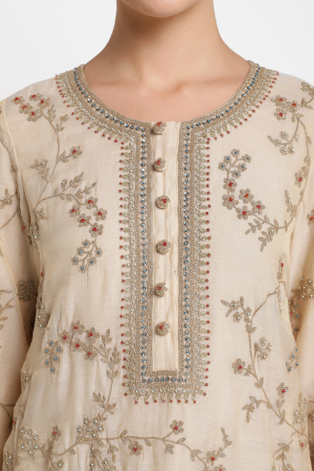 Beige embroidered dress with intricate patterns on a plain background