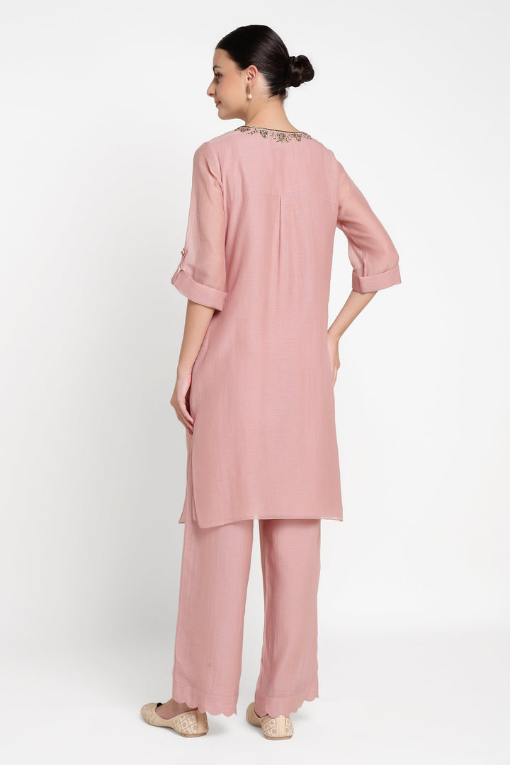 Woman wearing a pink outfit on a white background