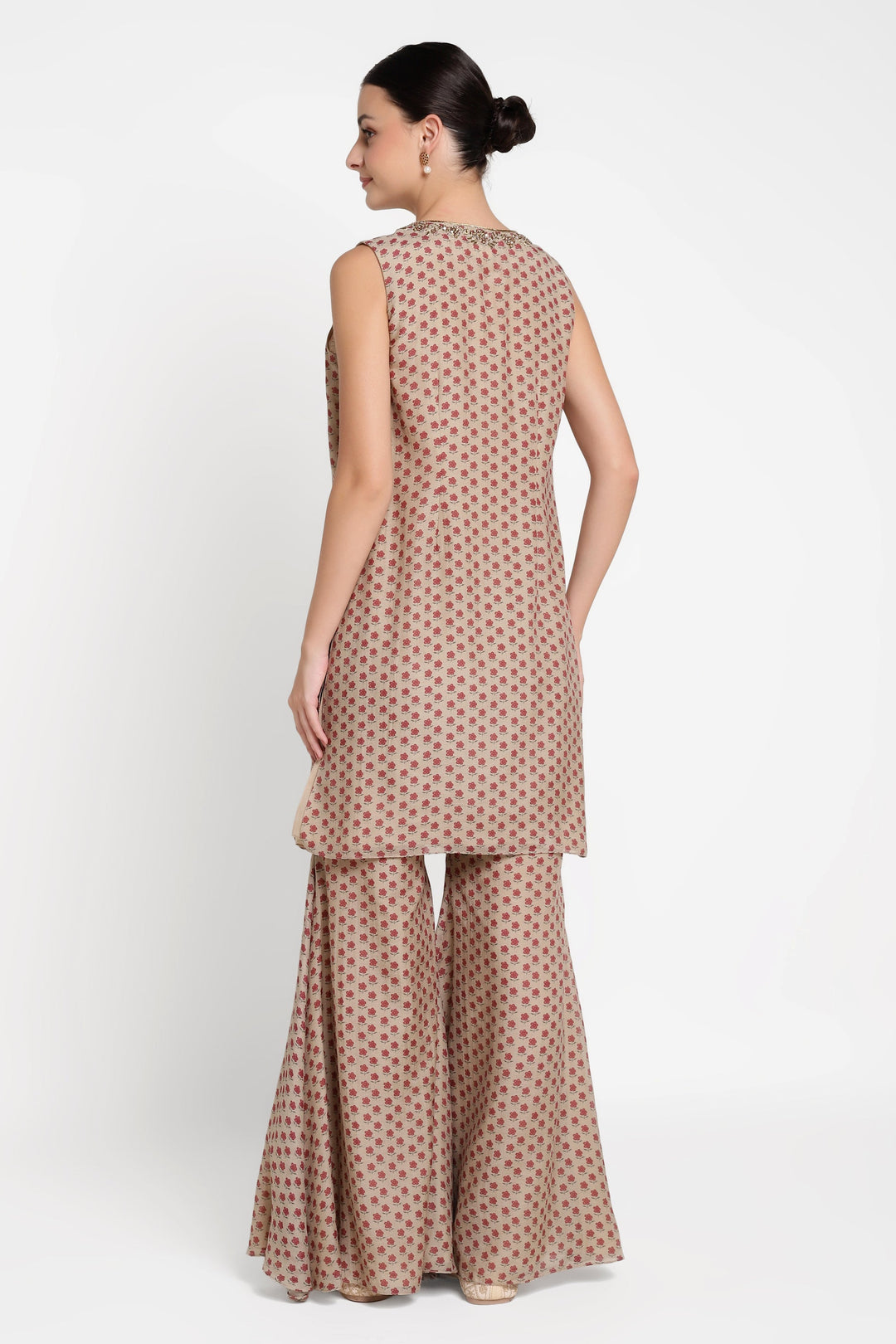 Woman wearing a patterned outfit on a white background