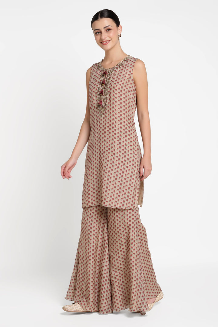 Woman wearing a brown patterned outfit on a white background