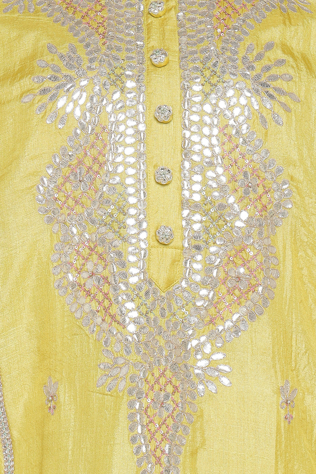 Close-up of a yellow garment with intricate silver embroidery