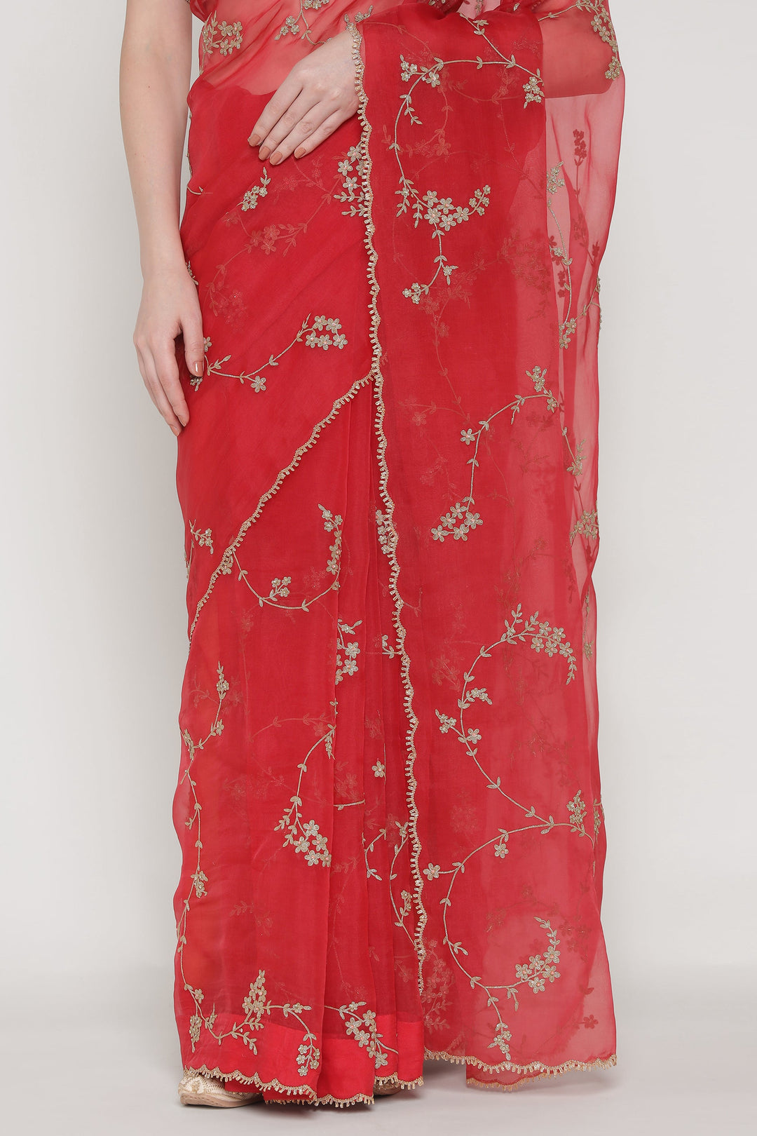 Red saree with floral embroidery on a white background