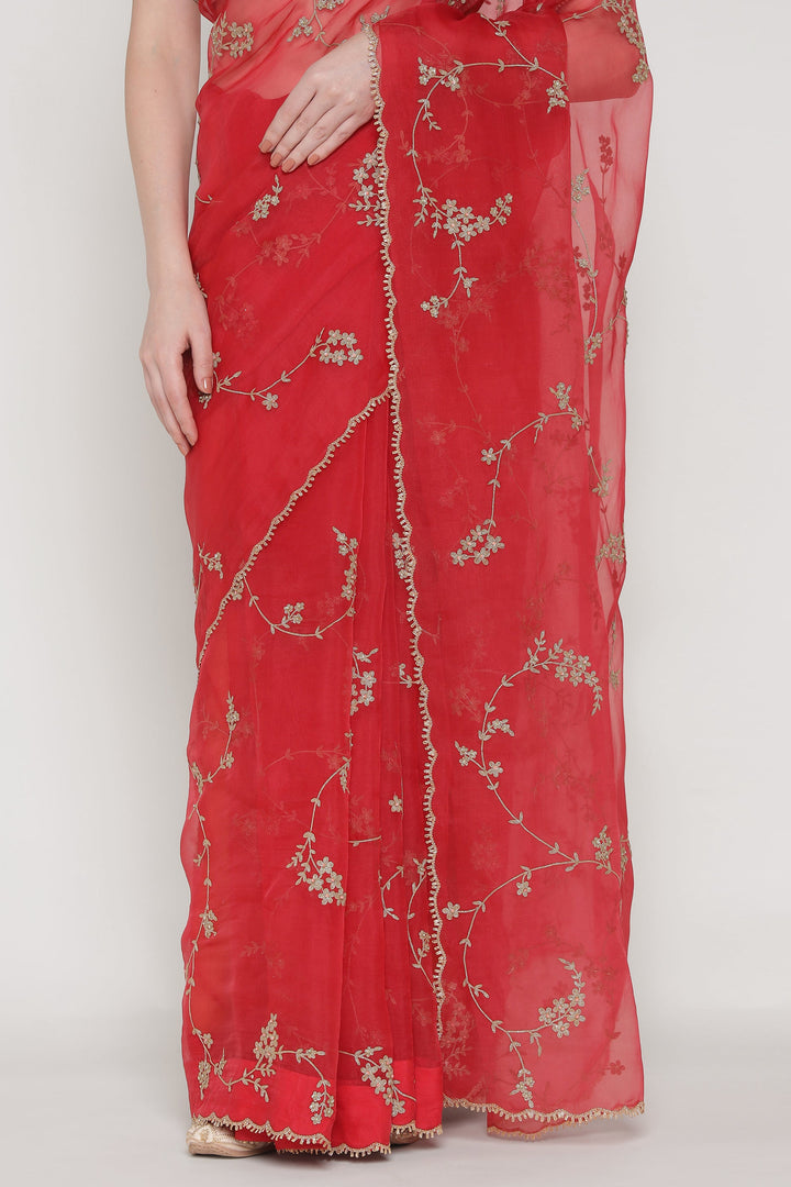 Red saree with floral embroidery on a white background