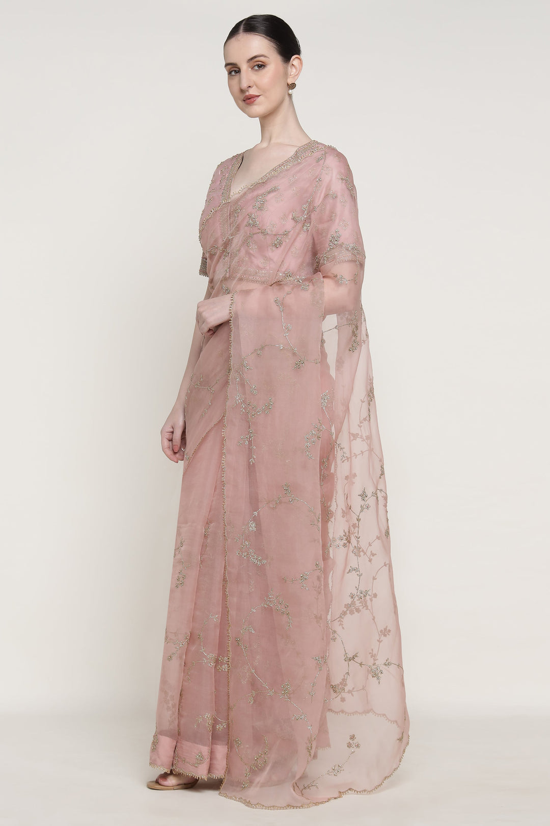 Woman wearing a pink floral dress on a white background