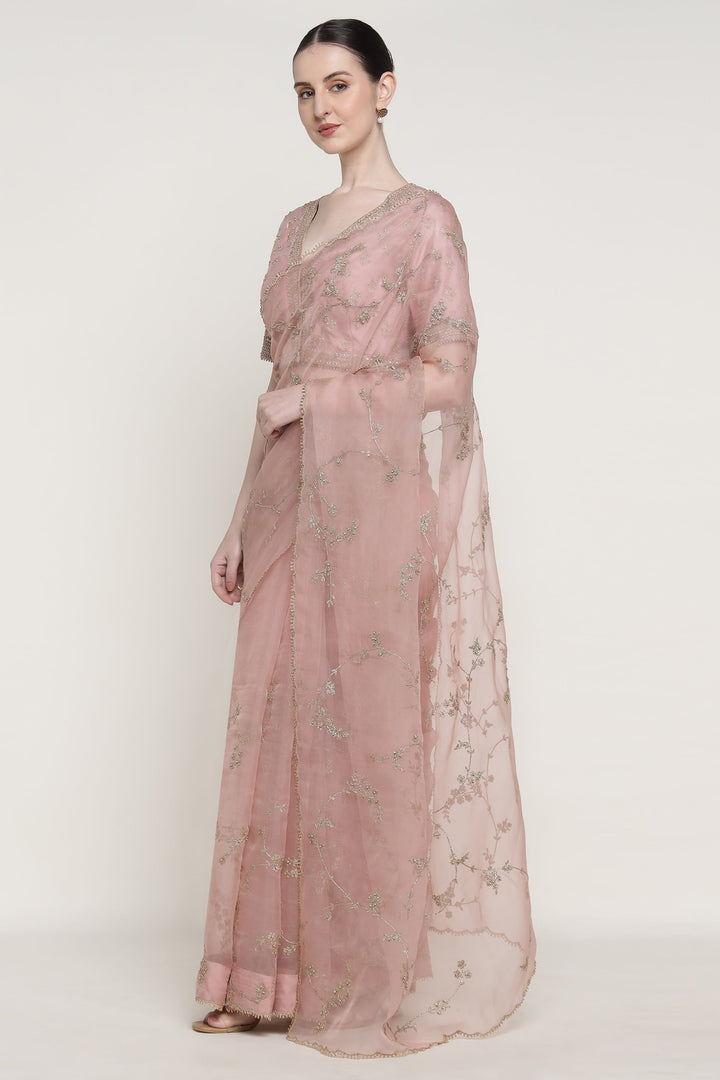 Woman wearing a pink floral dress on a white background