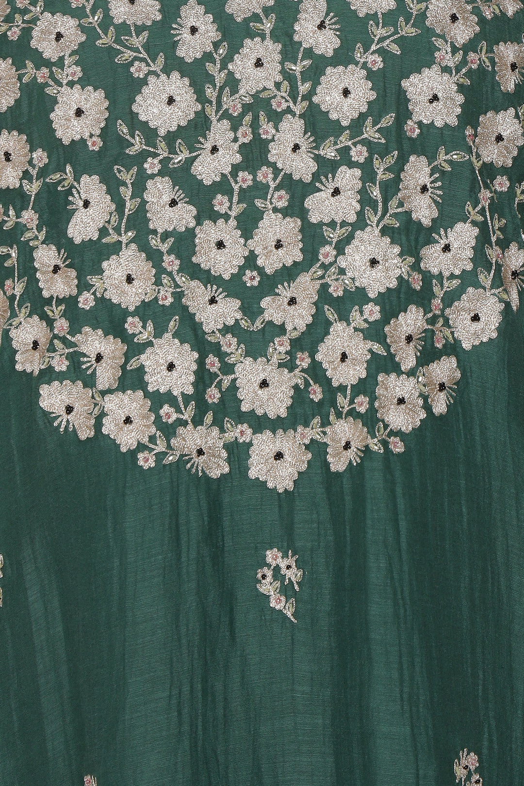 Close-up of a green fabric with white floral embroidery