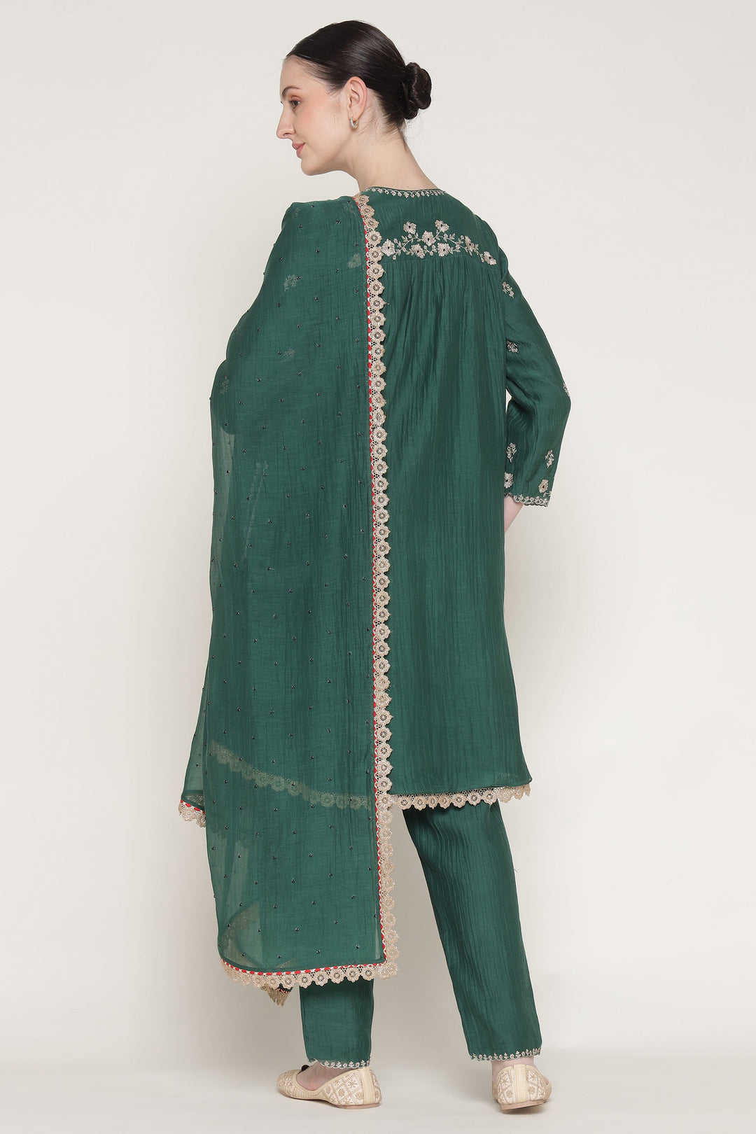 Green embroidered kurta with matching pants on a white background