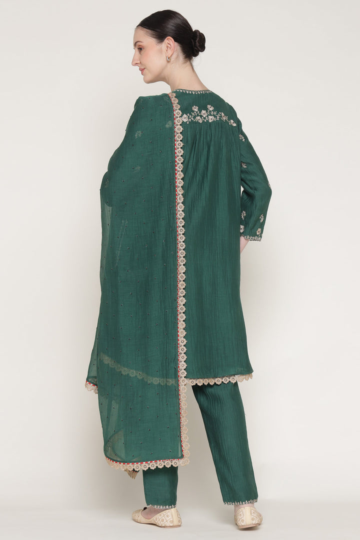 Green embroidered kurta with matching pants on a white background