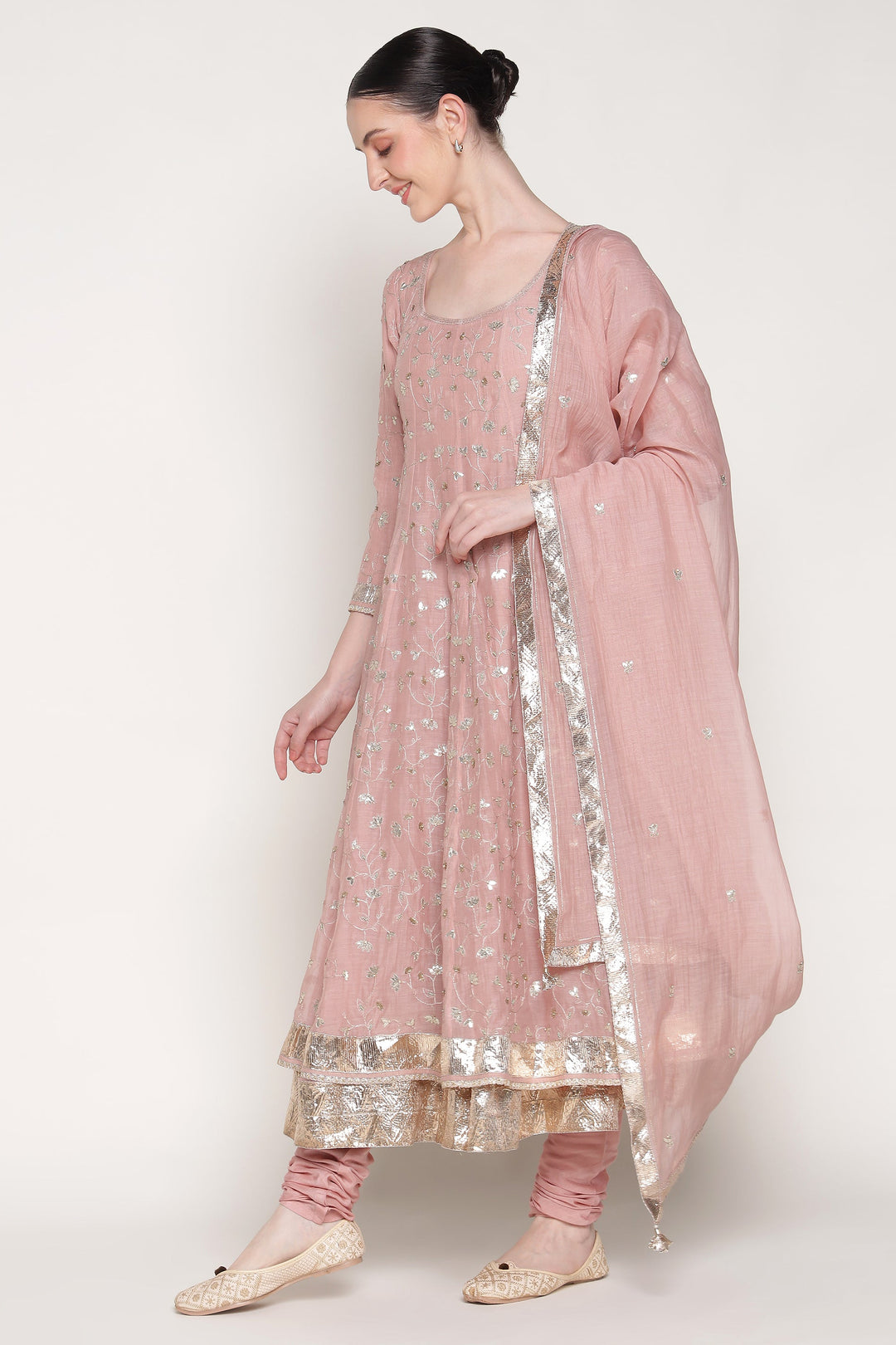 Woman wearing a pink traditional outfit with a white background