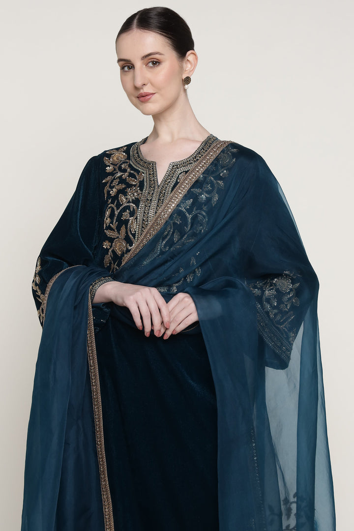 Woman wearing a dark blue embroidered shawl on a white background