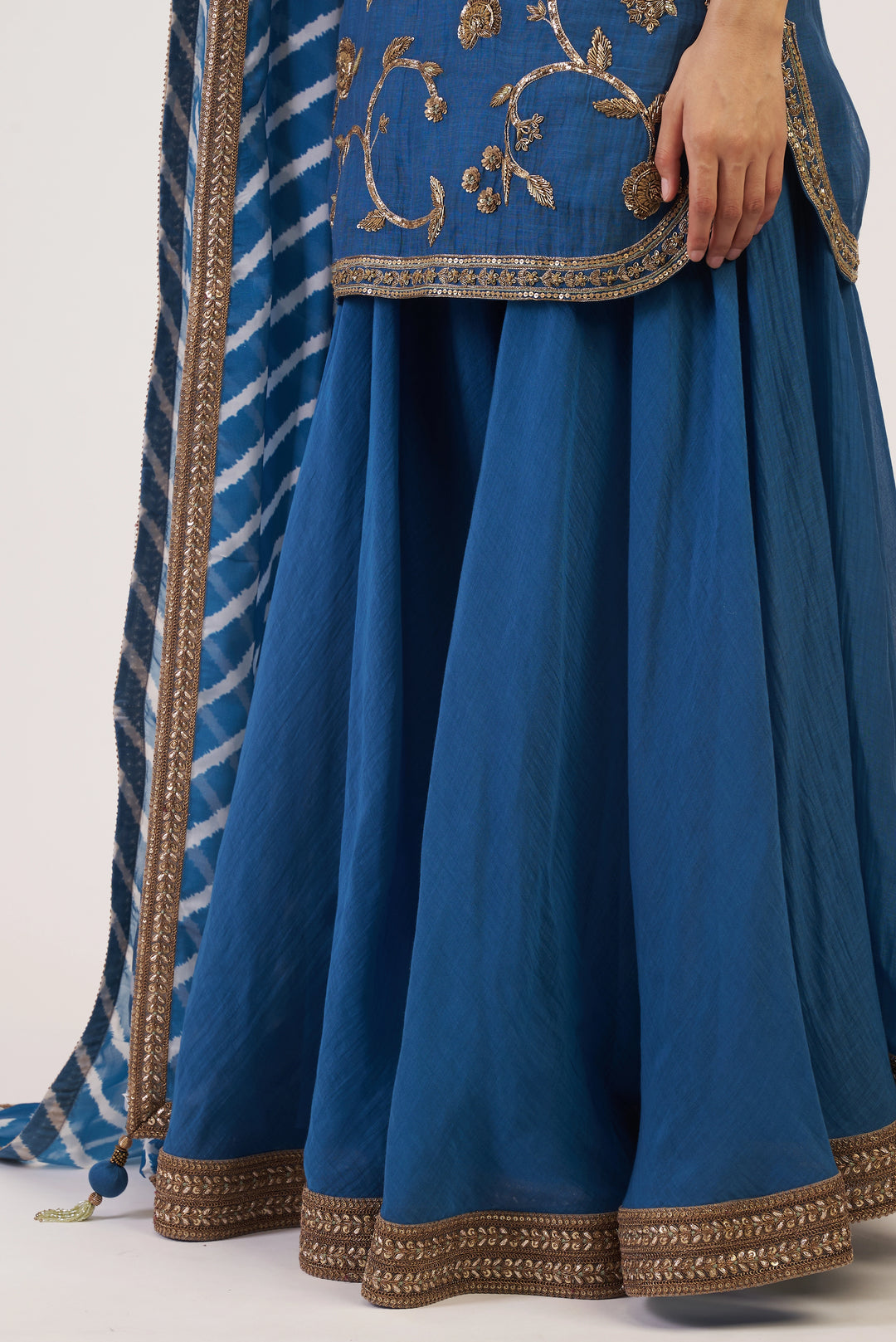 Blue traditional outfit with gold embroidery on a white background