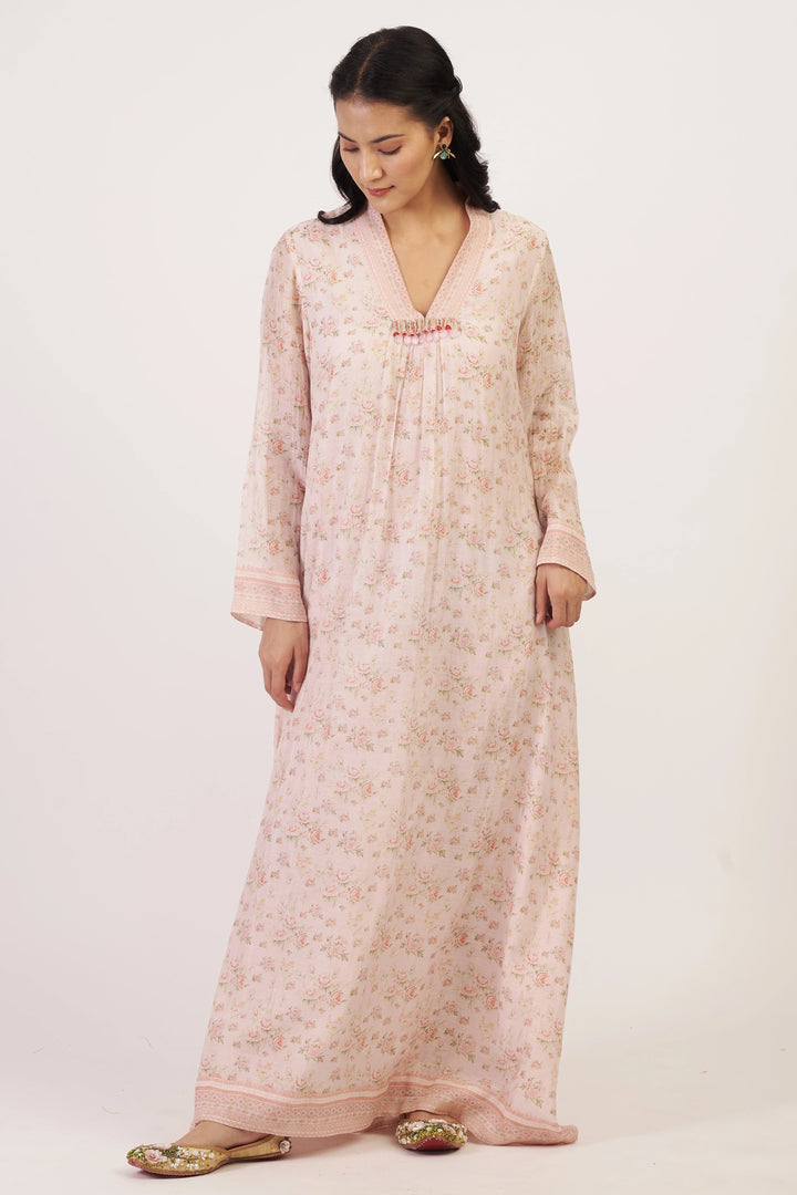 Woman wearing a long floral dress on a white background