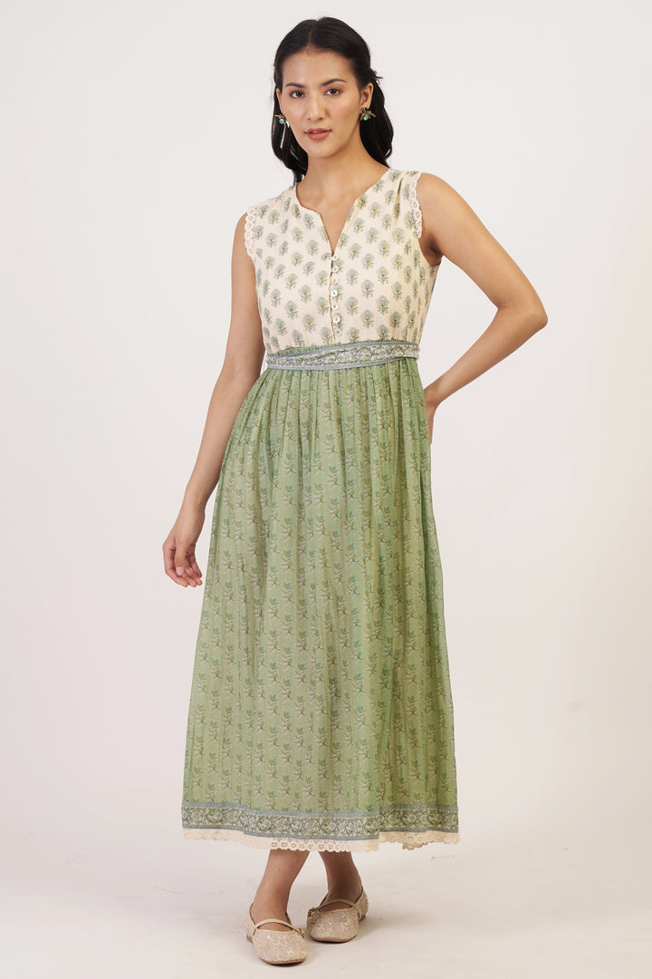 Woman wearing a sleeveless top and green skirt on a white background