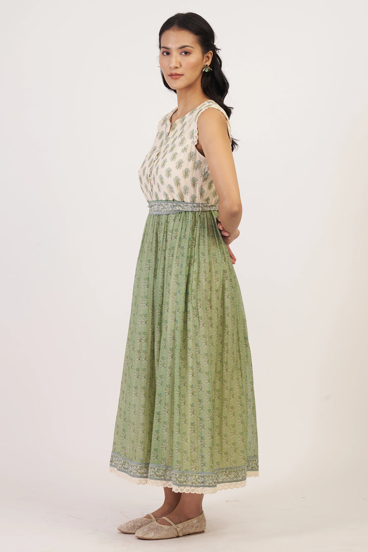 Woman wearing a sleeveless top and green skirt on a white background
